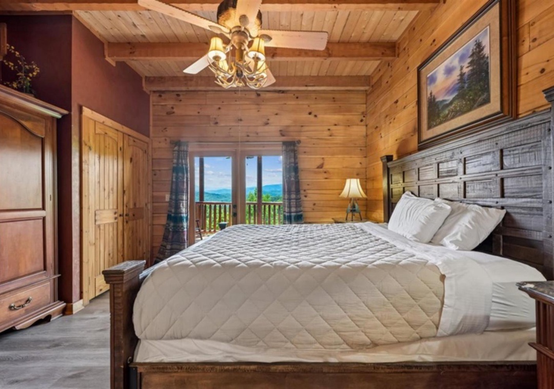 Wake up to stunning mountain views from your cozy cabin bedroom. Exposed wood beams and rustic charm create a warm retreat after a day exploring the Smokies.