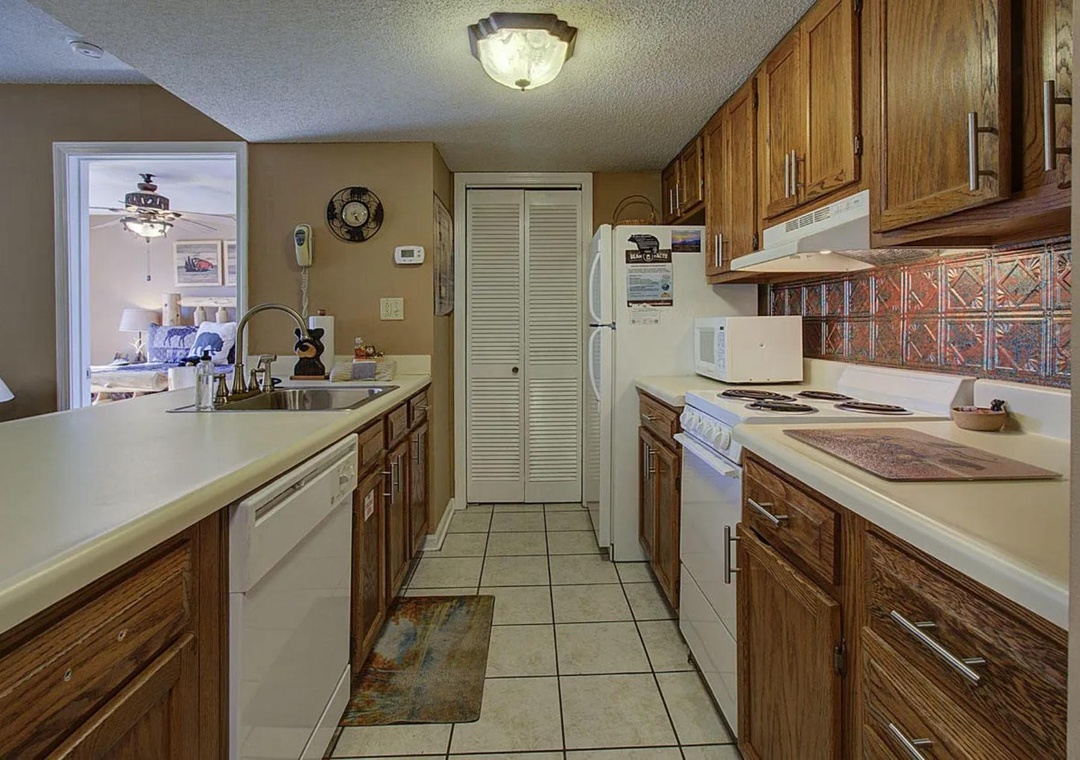 Your fully equipped galley kitchen features warm wood cabinets, ample counter space, and all the appliances you need to create memorable meals during your stay.
