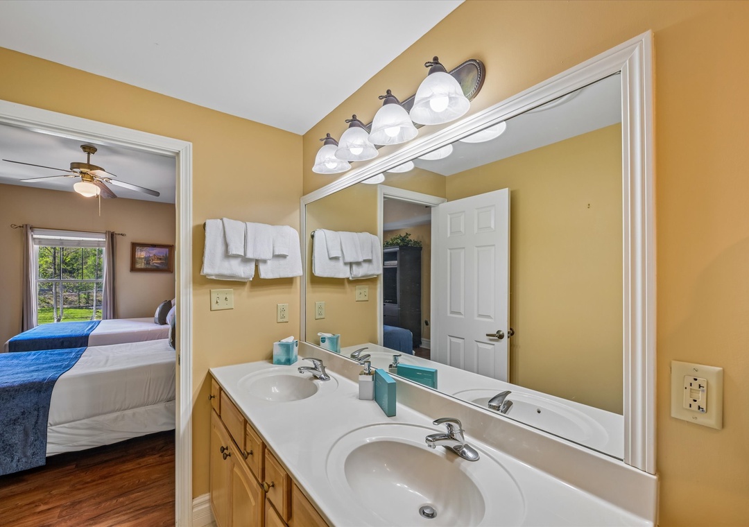 Step into your private en-suite bathroom with dual vanities, perfect for getting ready together in comfort.