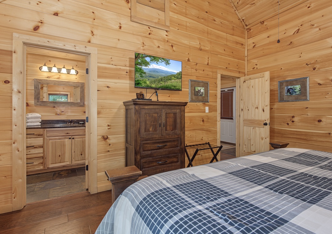 Relax in your cozy cabin bedroom with rustic wood accents and a private ensuite. Natural light and warm finishes create your peaceful mountain retreat.