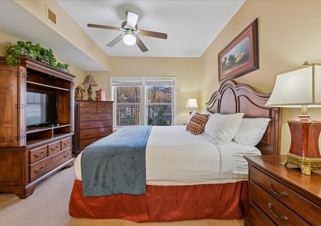 Rest peacefully in your elegant bedroom with rich wood furnishings, plush linens, and a ceiling fan keeping you comfortable all night long.