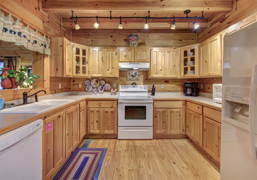 Cook comfortably in your rustic kitchen with warm wood cabinets, full appliances, and charming cabin touches.