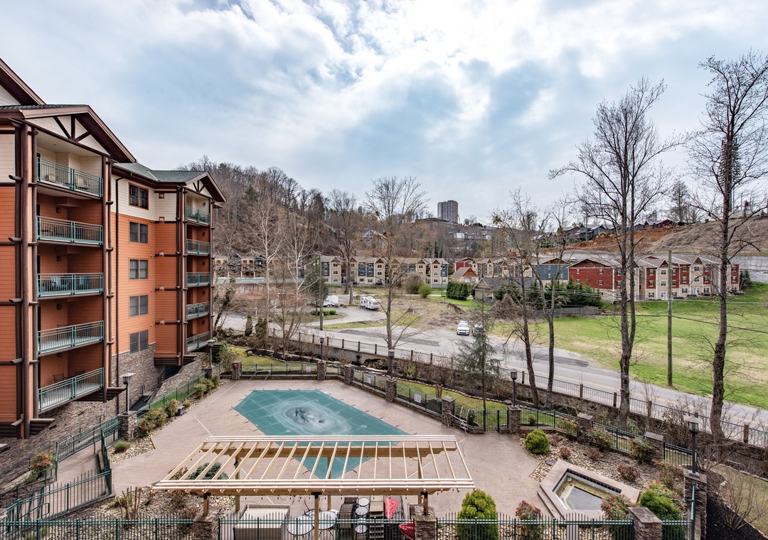 Elevated view showcasing the property's pool area and surrounding residential neighborhood with mountain backdrop.