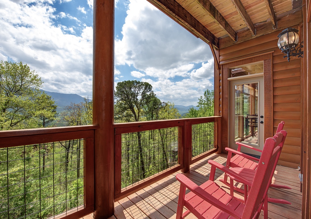 Unwind in red Adirondack chairs on your private deck, where mountain vistas and forest canopy create the perfect backdrop for morning coffee.