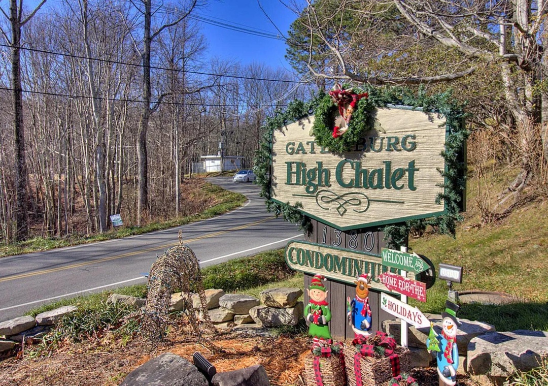 Gatlinburg High Chalet entrance sign adorned with festive holiday decorations welcomes visitors to this mountain community.