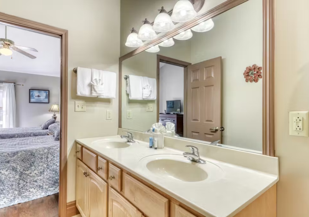 Your private bathroom features a spacious vanity with ample storage and connects seamlessly to your bedroom.