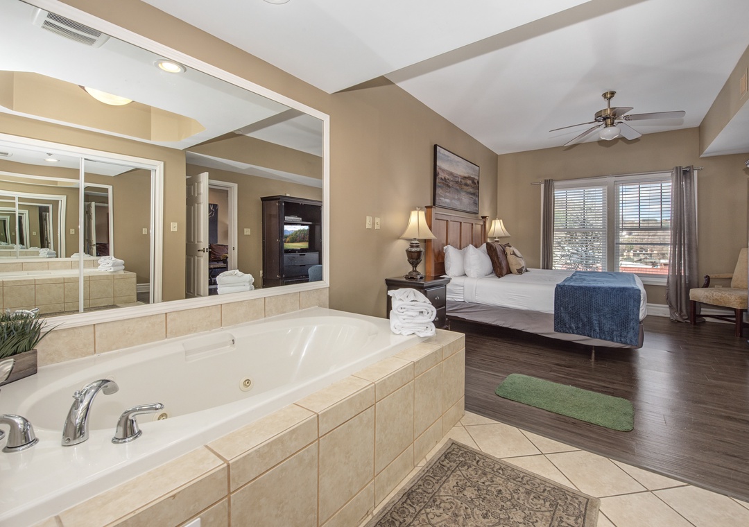 Your luxurious suite features a romantic jetted tub overlooking the bedroom, creating an intimate spa-like retreat.
