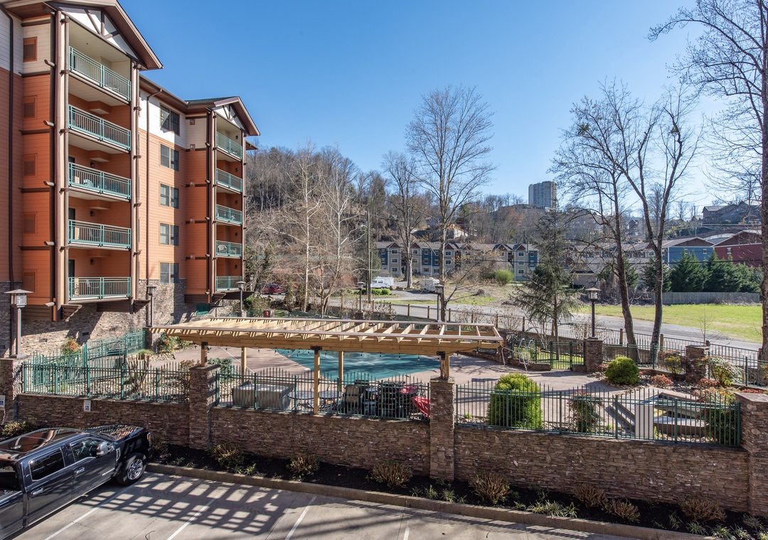 Modern resort-style complex featuring outdoor pool and scenic mountain views in a peaceful neighborhood setting.