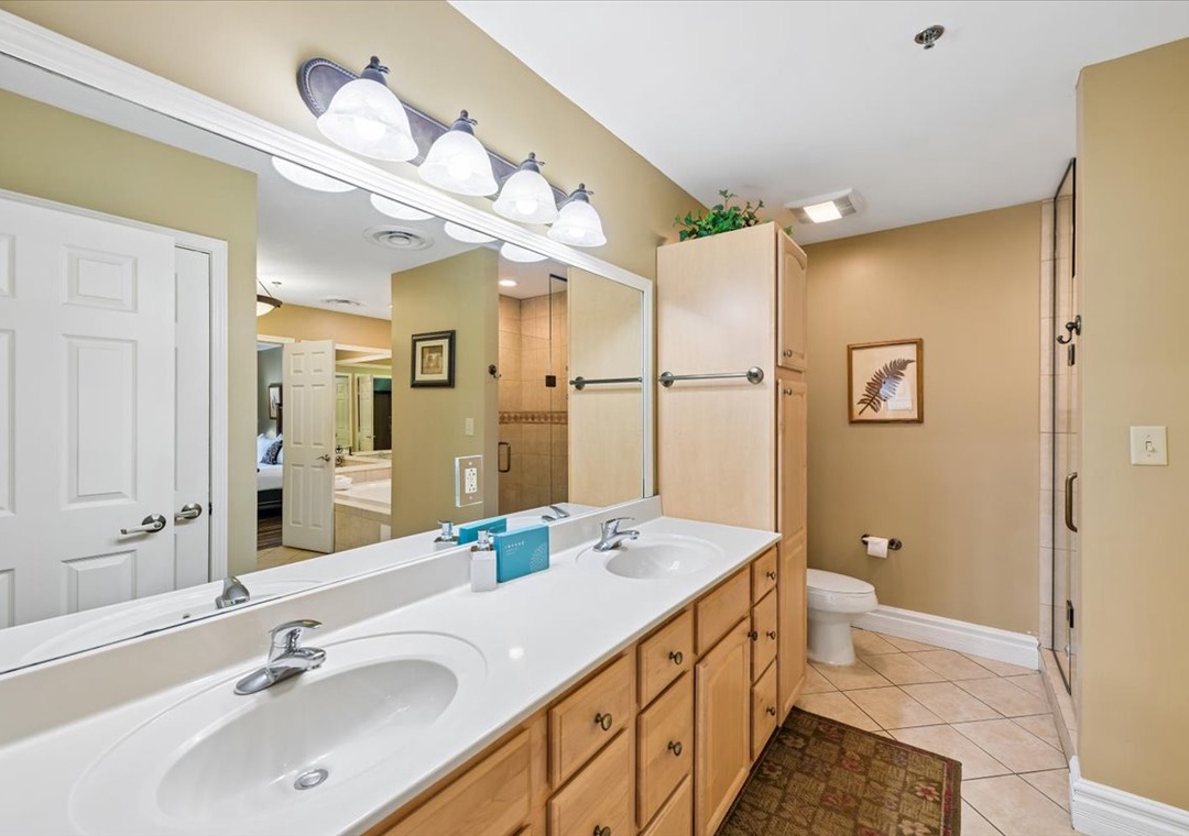 Your master bathroom features dual sinks with warm lighting and spacious vanity for morning routines together.