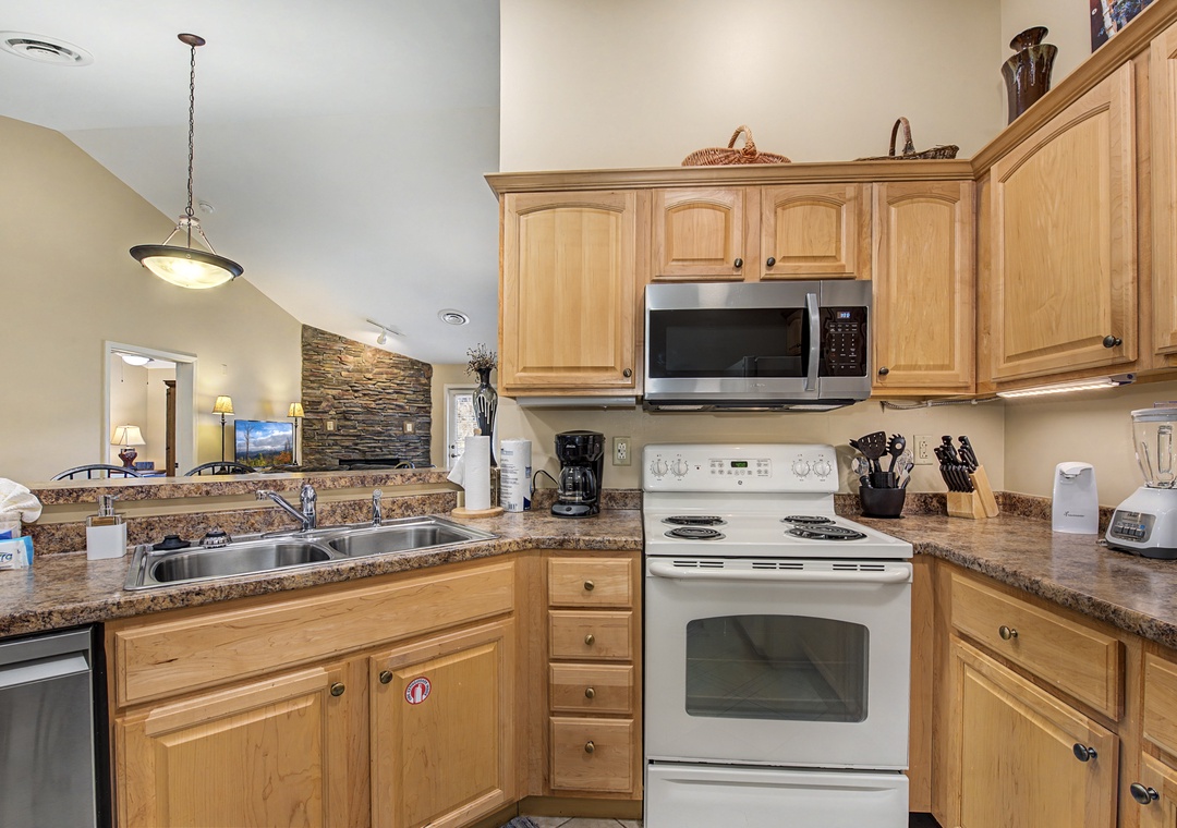 You'll love cooking in this fully equipped kitchen with warm wood cabinets, granite counters, and everything needed for memorable meals.