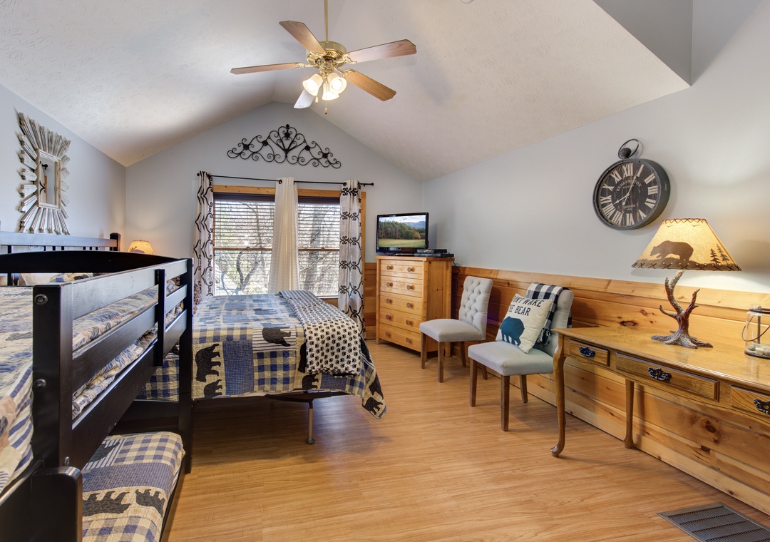 You'll love this cozy bedroom with rustic charm, featuring comfortable bunk beds and twin bed perfect for family gatherings.