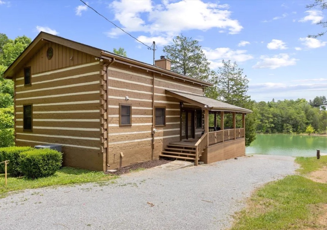Charming log cabin retreat positioned perfectly beside a serene lake, offering tranquil waterfront views and peaceful natural surroundings.