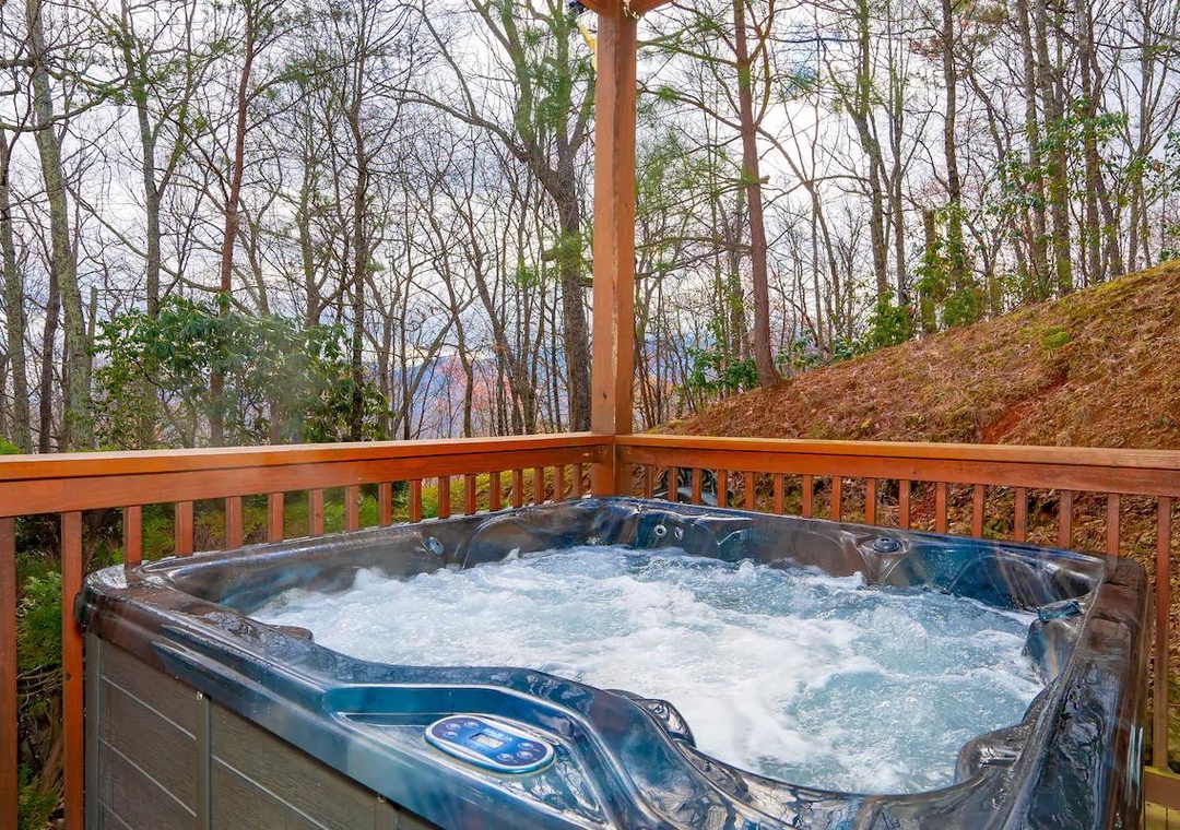 Sink into bubbling warmth while surrounded by peaceful forest views from your private deck sanctuary.
