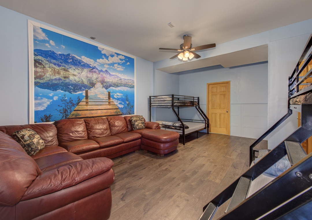 Unwind on plush leather seating beneath a stunning mountain lake mural, with bunk beds for the kids nearby.
