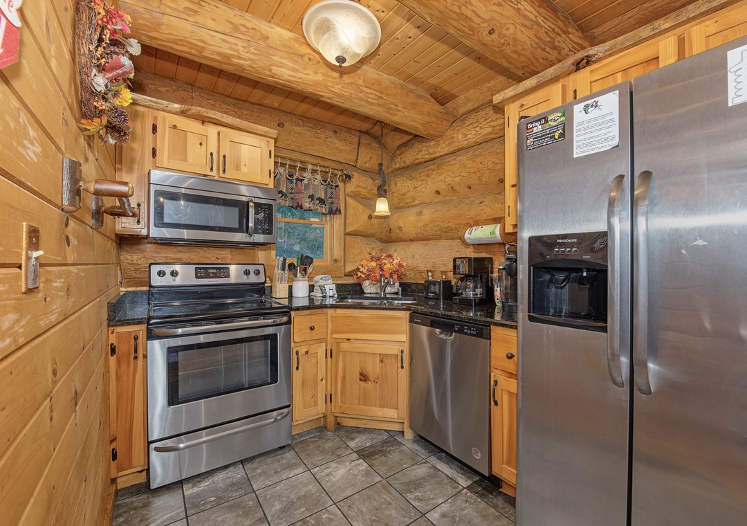 Cook up your favorite meals in this fully equipped kitchen, complete with stainless steel appliances and plenty of cabinet storage under warm wood paneling.