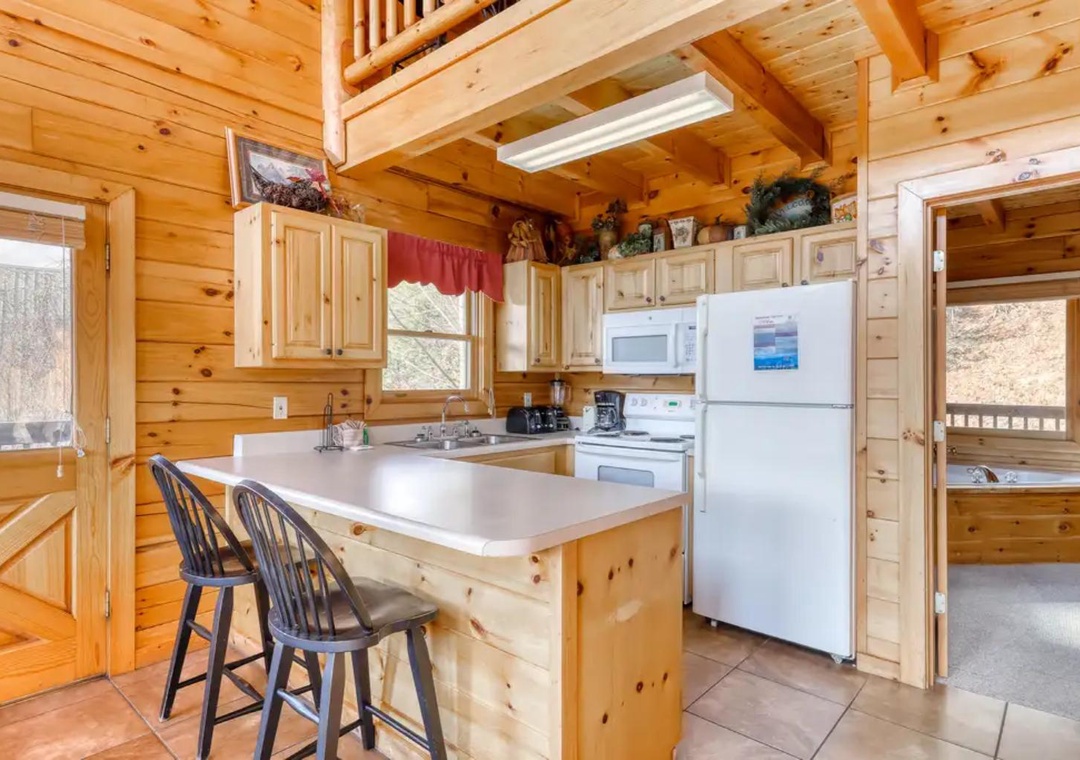 Step into your fully equipped kitchen with rustic wood charm, where you'll find everything you need to create memorable meals under soaring timber ceilings.