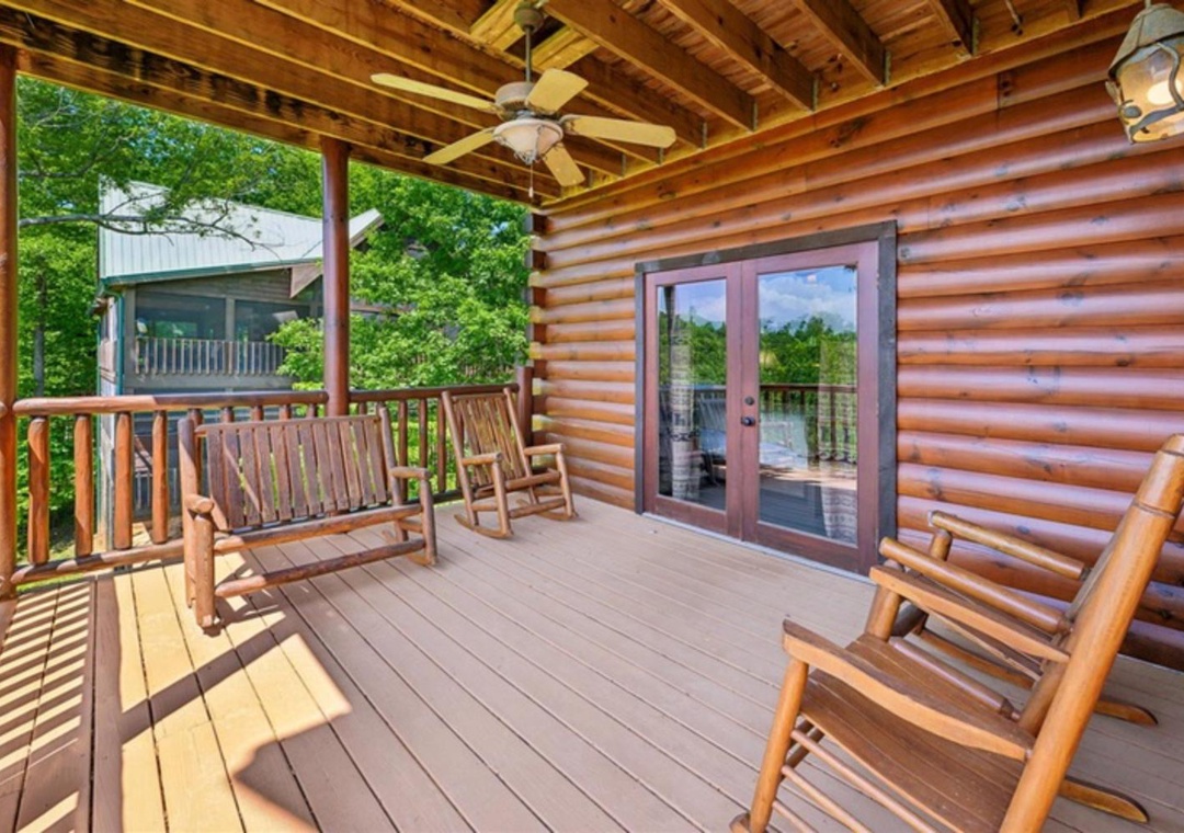 Relax on your private covered deck with rustic log furniture and peaceful wooded views. The perfect spot to unwind with morning coffee or evening conversations.