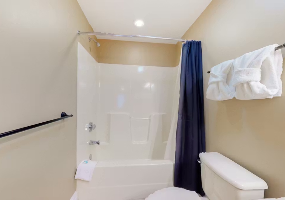 Step into your private bathroom featuring a full tub-shower combo with fresh towels waiting for you.