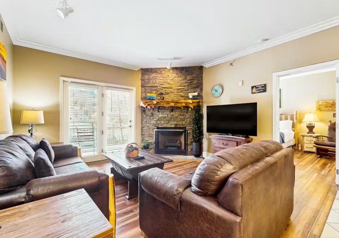 Sink into plush leather sofas by your stone fireplace while streaming shows on the large TV. This warm, elegant space invites you to unwind.