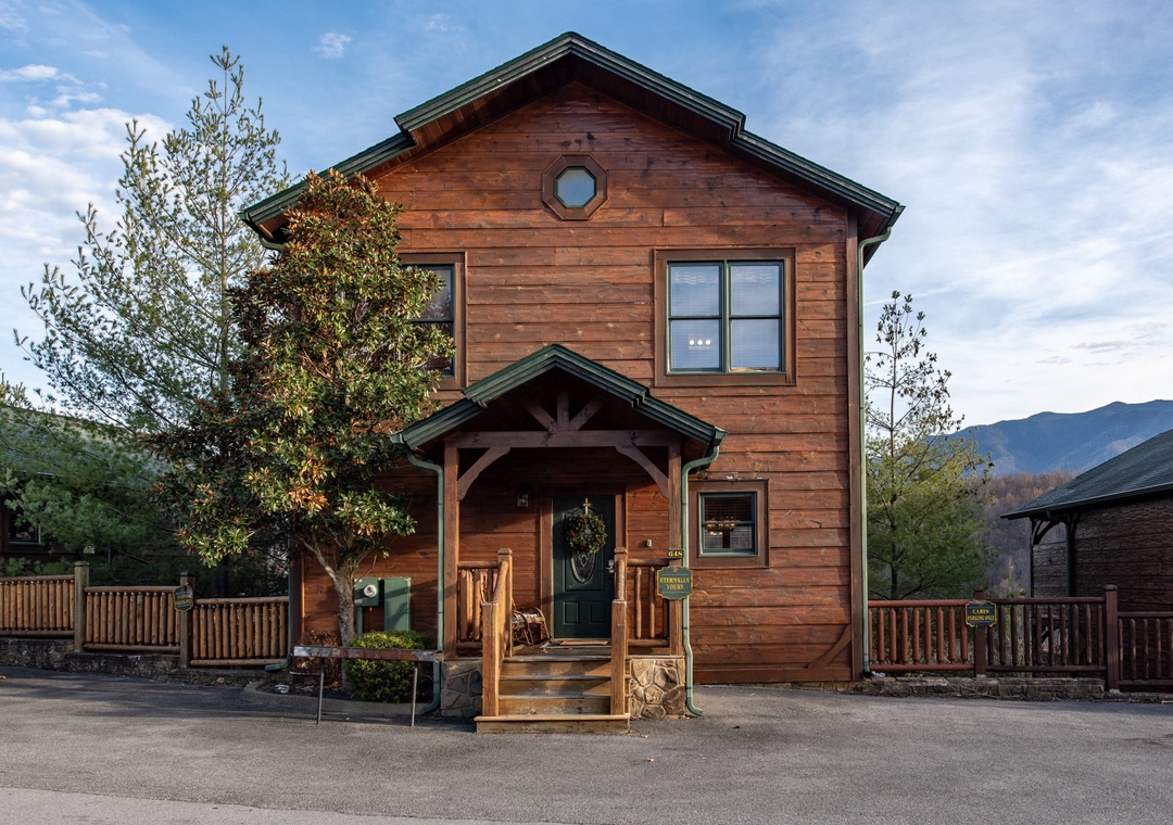 A charming two-story wood cabin nestled in a mountain resort community, offering a cozy alpine retreat with stunning views of the surrounding peaks and natural landscape.