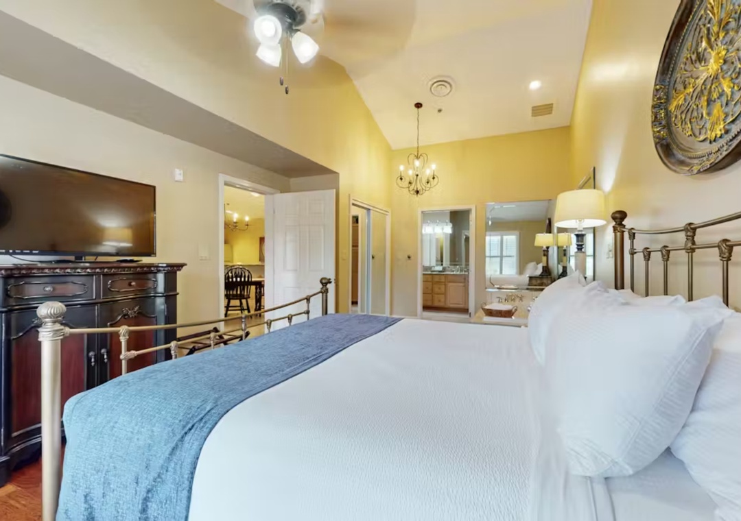 Sink into luxurious linens on your king bed while enjoying the warm ambiance of this elegant suite with high ceilings.