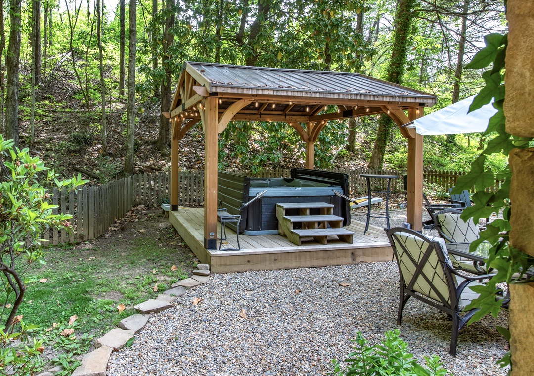 Soak under the stars in your private hot tub, surrounded by tranquil forest and thoughtfully placed seating for ultimate relaxation and privacy.