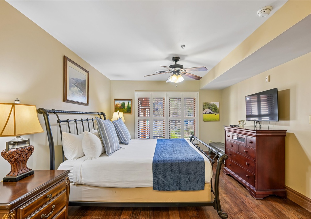 Sink into crisp linens and let the gentle ceiling fan create your perfect sleeping temperature in this elegantly appointed bedroom.