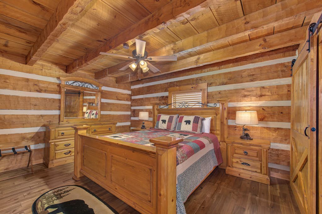 Unwind in your cozy log cabin bedroom, where warm wood beams and rustic charm create the perfect retreat after a day of mountain adventures.