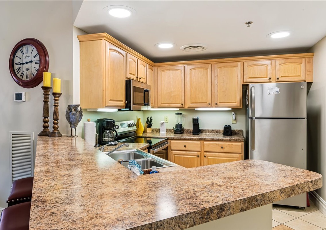 Your fully equipped kitchen features granite countertops, stainless steel appliances, and ample cabinet space for preparing memorable meals together.
