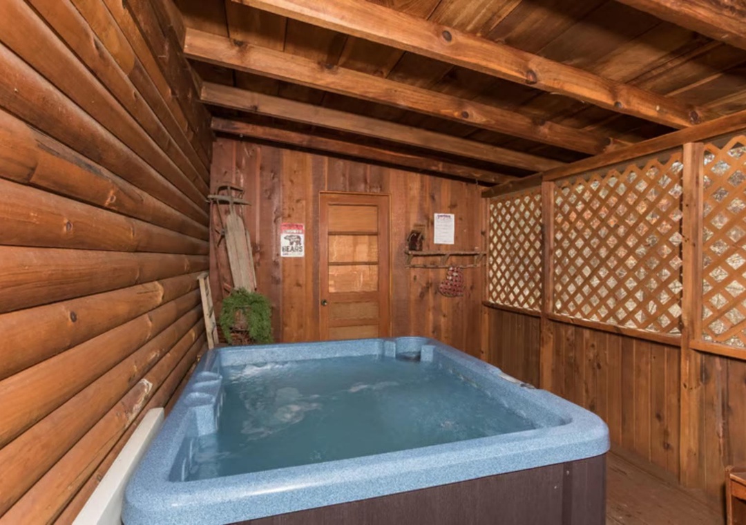 Slip into your private hot tub and let the warm water melt away stress under the cozy shelter of this rustic wooden deck. The lattice panels and timbers create a peaceful, intimate escape perfect for unwinding after a day exploring the mountains.