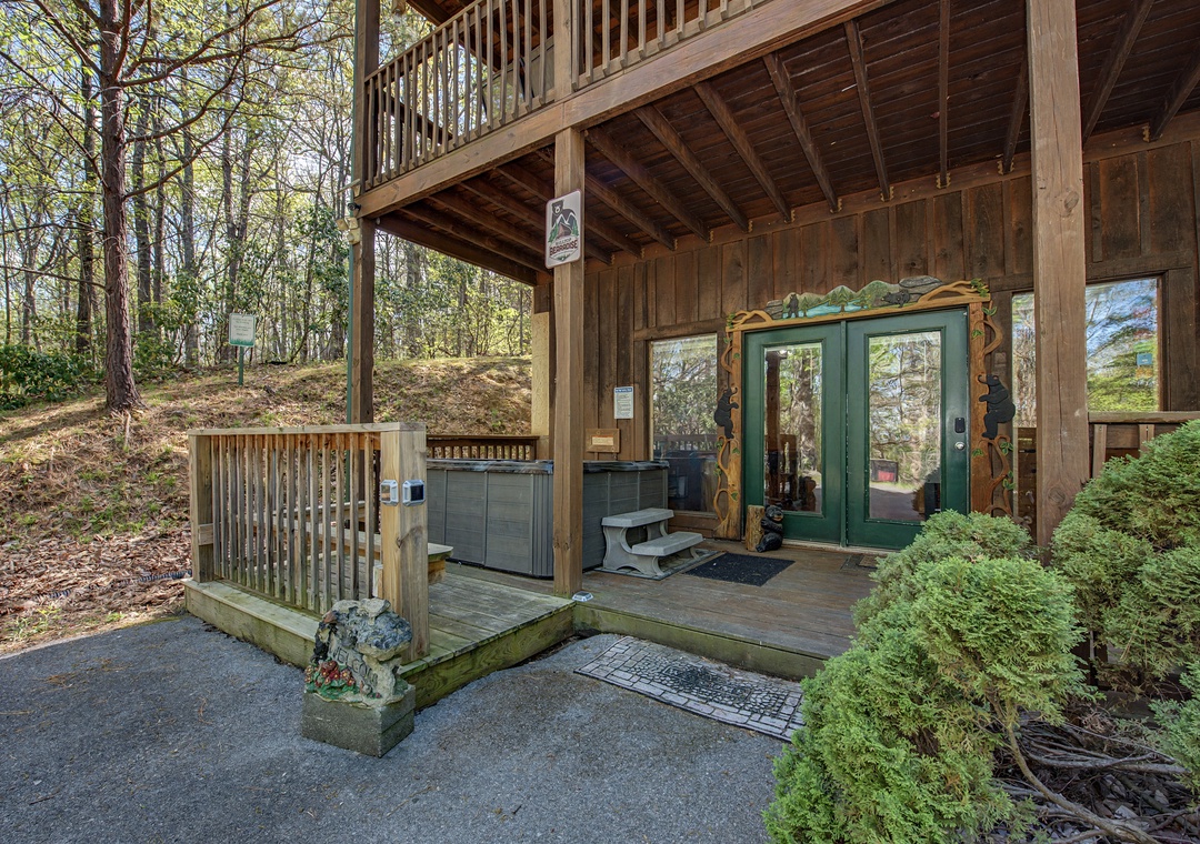 Charming mountain cabin entrance with rustic wooden architecture and forested surroundings.