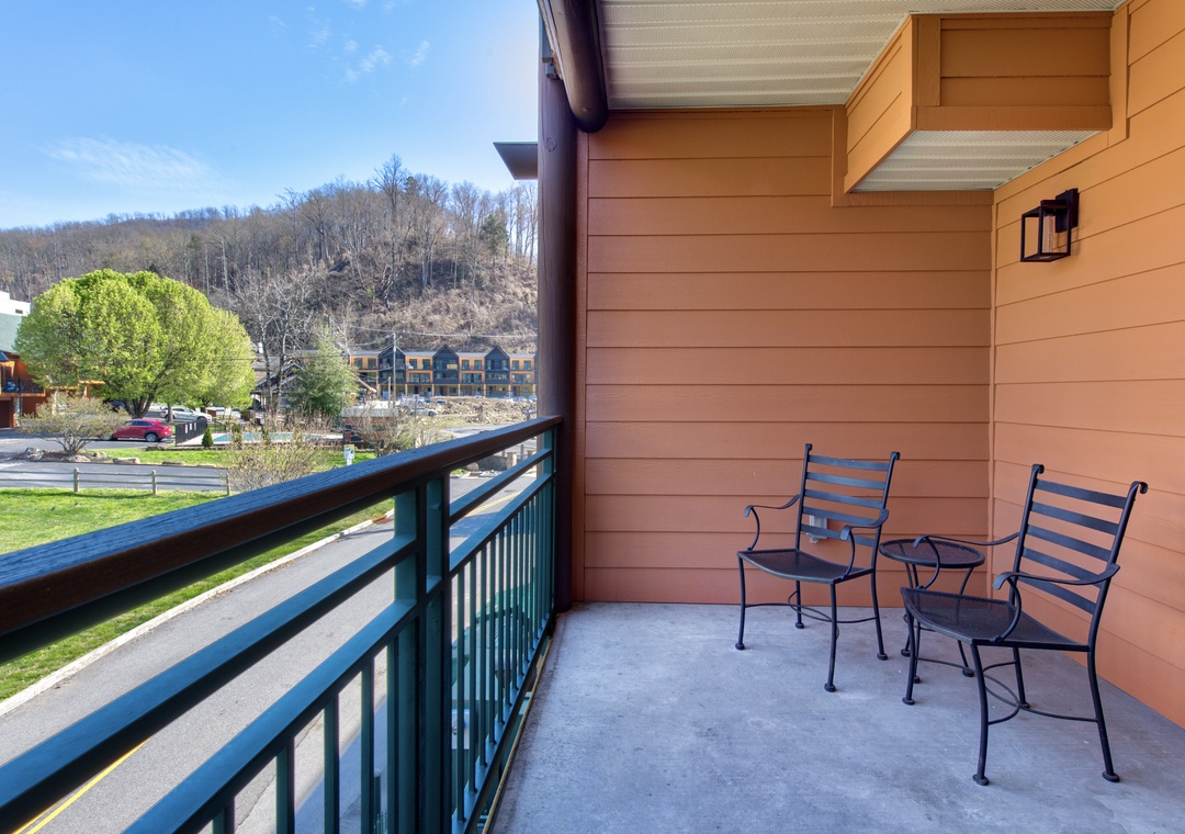 Step onto your private balcony to enjoy mountain views while sipping morning coffee in comfortable outdoor seating.