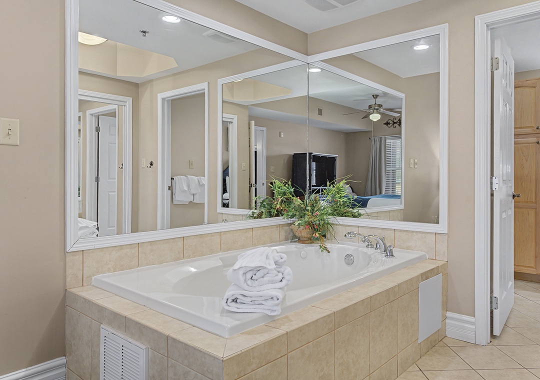 Slip into your private jetted tub surrounded by elegant mirrors, where fluffy towels await your relaxing soak.