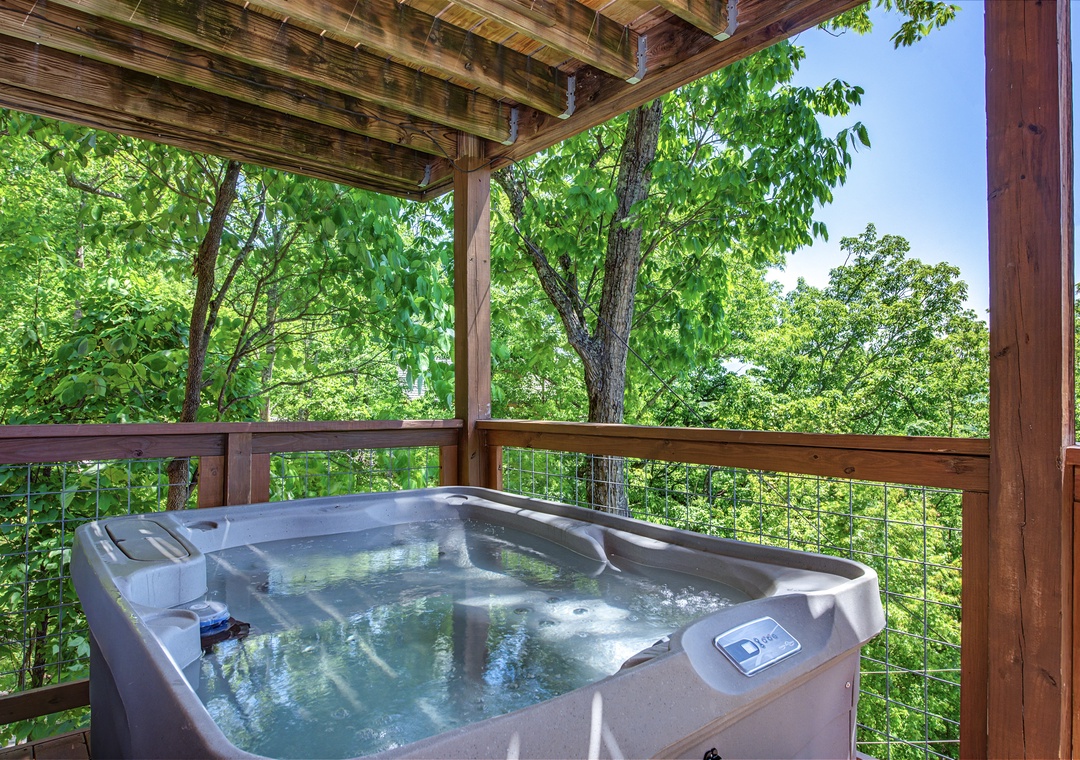 Slip into the bubbling hot tub surrounded by lush, vibrant treetops—your own private oasis where you can unwind and breathe in the fresh forest air.