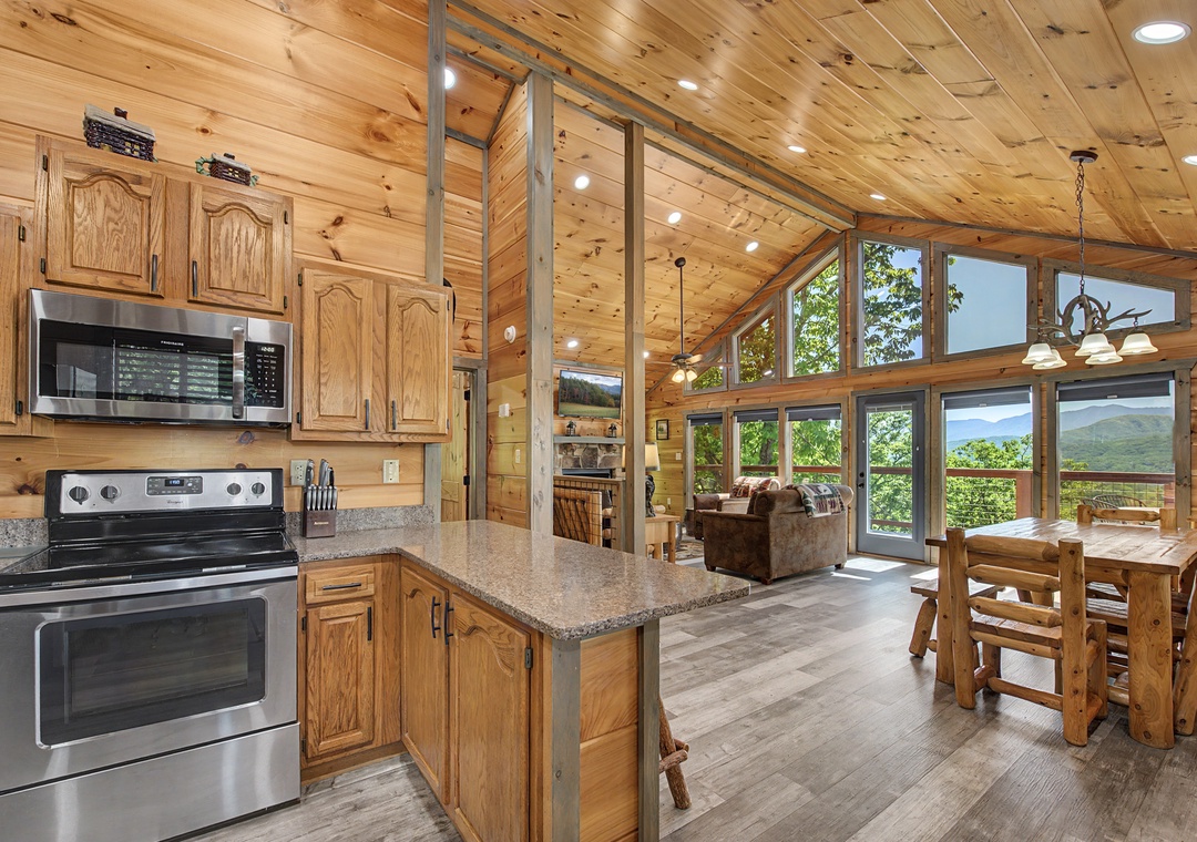 Open kitchen flows into your living and dining area, framed by soaring ceilings and stunning mountain vistas through walls of windows.