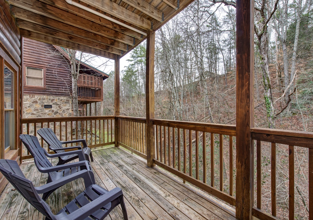 Step onto your private covered deck and unwind in comfortable chairs while taking in the peaceful wooded surroundings.