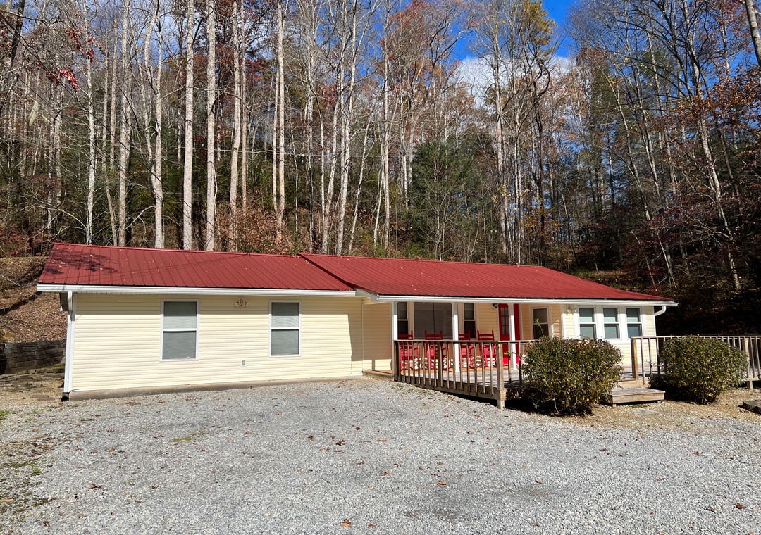 Charming mountain retreat nestled among autumn trees with private parking and peaceful forest surroundings.