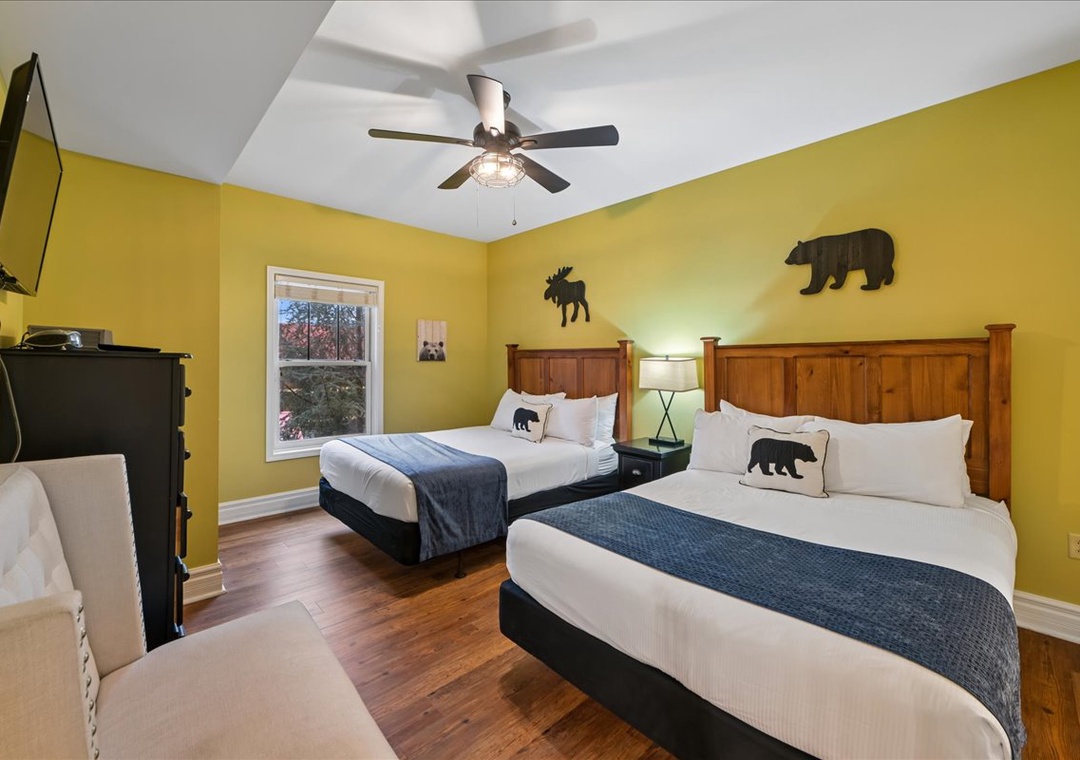 Rest comfortably in your cozy mountain-themed bedroom with two queen beds, rustic headboards, and charming bear accents throughout.