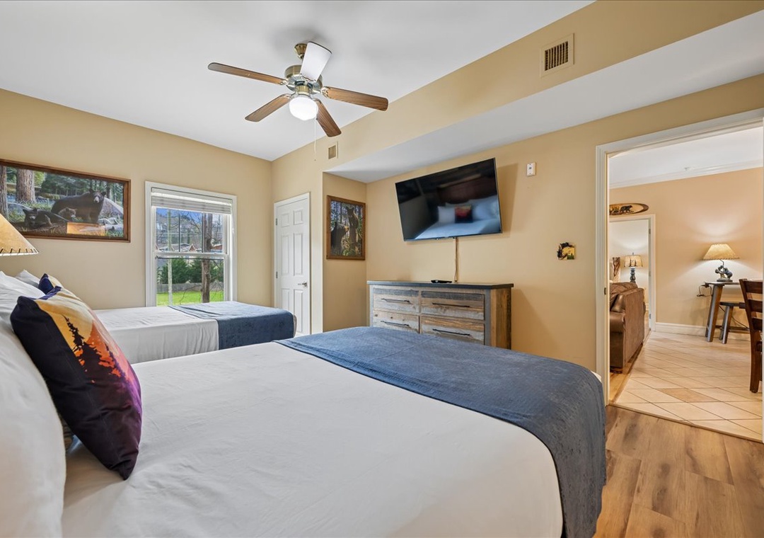Drift into peaceful sleep in your comfortable twin bed setup, with gentle ceiling fan and natural light streaming through the window.
