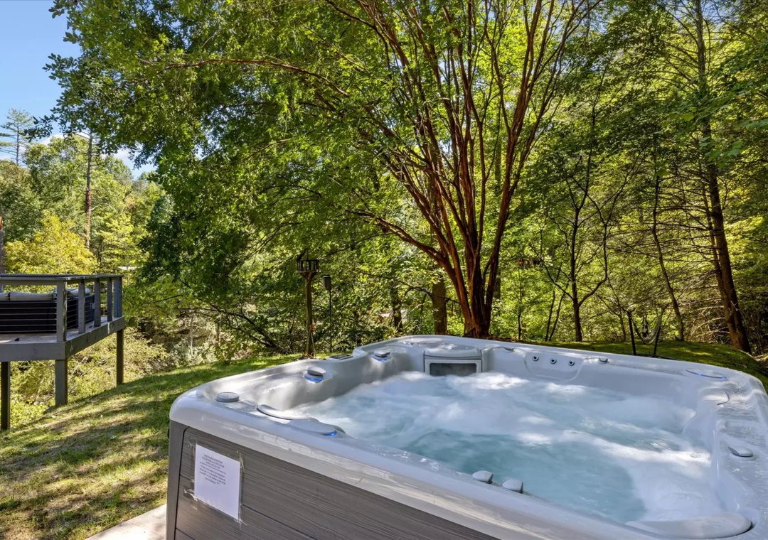 Soak in bubbling warmth while surrounded by towering trees and tranquil forest views from your private hot tub retreat.