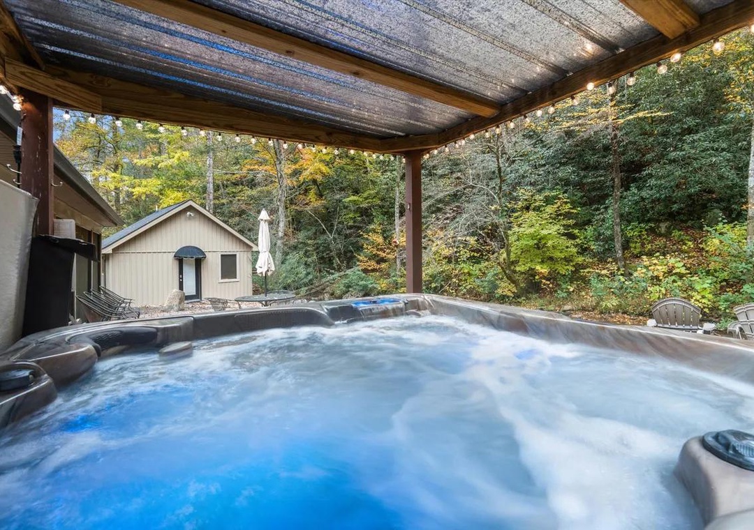 Soak away your cares in your private hot tub, sheltered beneath a wooden pergola while surrounded by peaceful forest views.