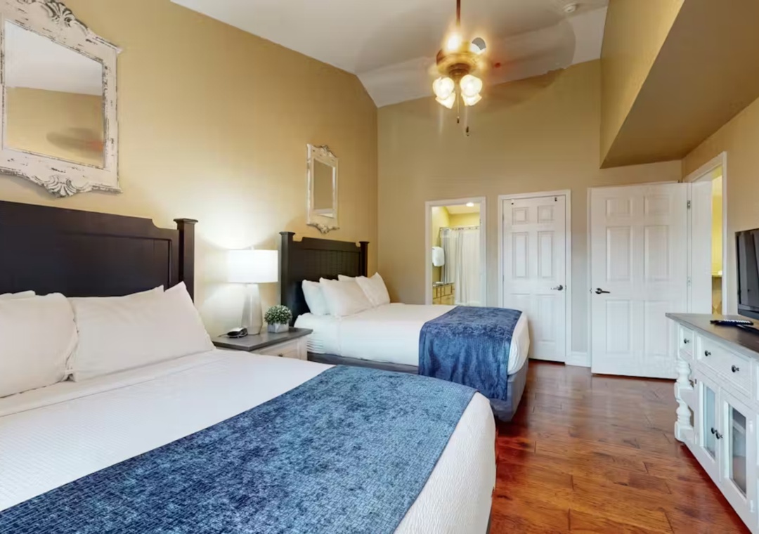 Settle into your comfortable twin beds with crisp linens and elegant blue accents, perfect for a restful night's sleep.