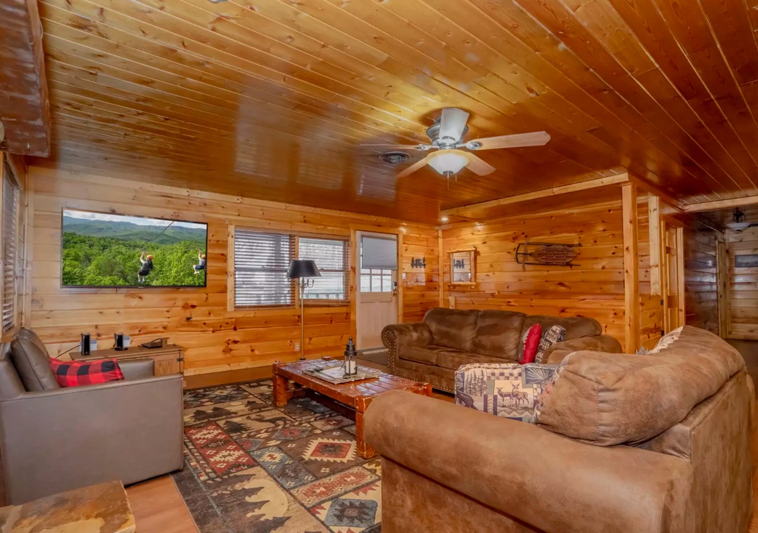 Gather in your cozy log cabin living room with plush leather seating and rustic charm for memorable mountain evenings.
