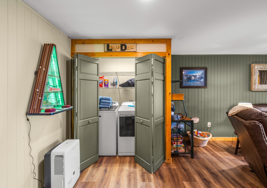 Step into your cozy retreat featuring handy laundry facilities and a welcoming lounge space with rustic charm and modern comforts for your mountain getaway.