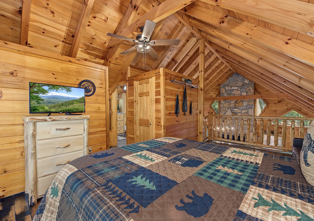 Drift off in your private loft bedroom under vaulted wood ceilings, where rustic charm meets comfort. A ceiling fan keeps you cool, and the hand-crafted log furniture adds a cozy cabin feel.