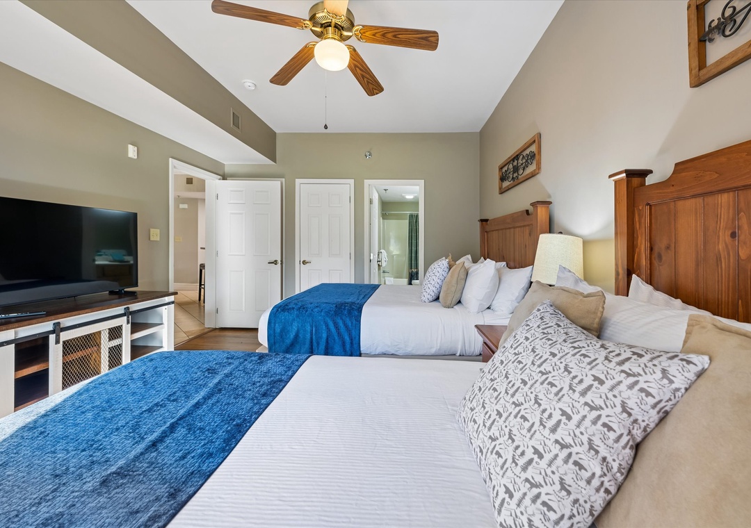 Unwind in your spacious bedroom with two plush beds, ceiling fan, and flat-screen TV for the perfect mountain getaway.
