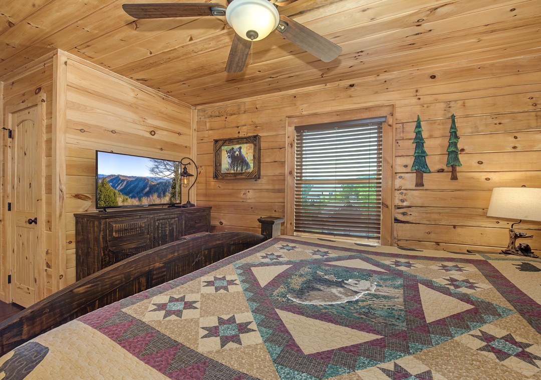 Drift off in your cozy bedroom with rustic wood walls, mountain views on TV, and a handmade quilt that wraps you in comfort.