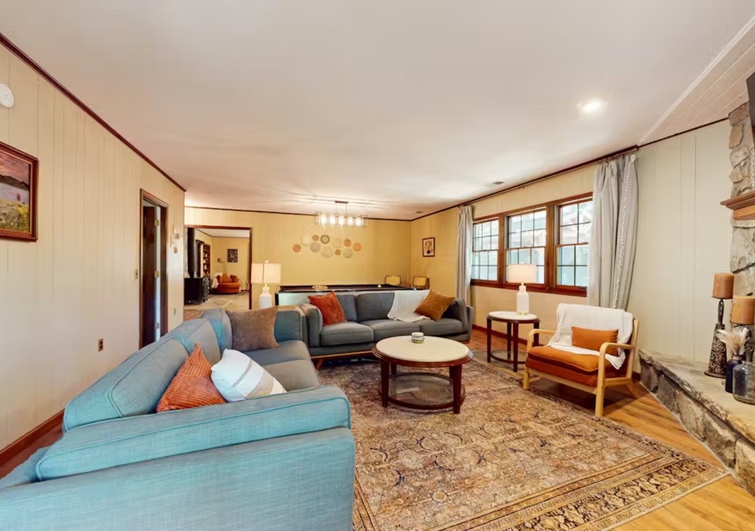 Sink into plush sofas by your stone fireplace, where warm colors and rich wood details create the perfect gathering space for your group.