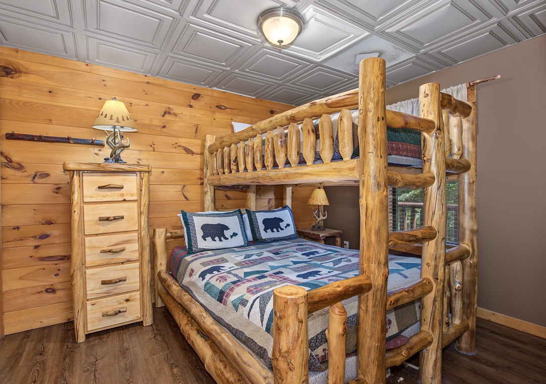 Step into your rustic retreat with handcrafted log bunk beds that bring mountain charm right to your room. The warm pine walls and cozy cabin details invite you to unwind after a day of adventure.