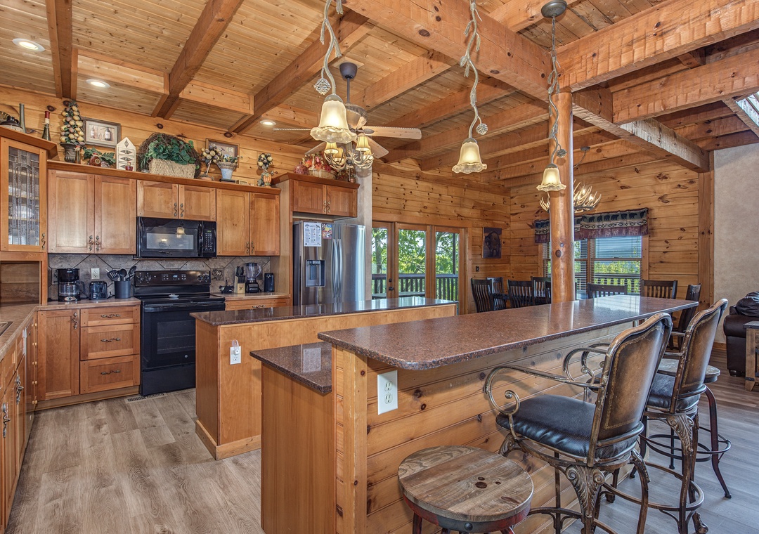 Spacious island kitchen with rustic timber beams and warm wood accents flows seamlessly into the dining area, perfect for meal prep and gathering.